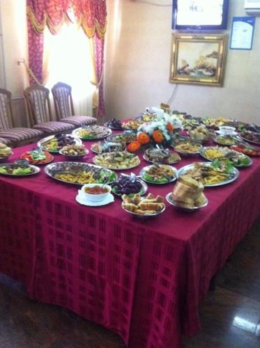 a table with plates of food on top of it at Business Club Selenča in Bač