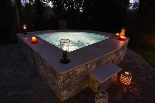 a stone plunge pool with candles and candles at Villa Onar a stone house with amazing view in Stoupa