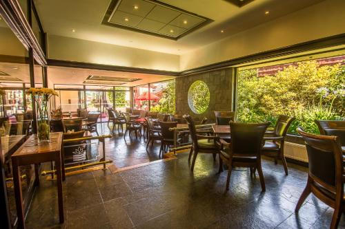 a dining room with tables and chairs in a restaurant at Hotel Marina Villa del Rio in Valdivia