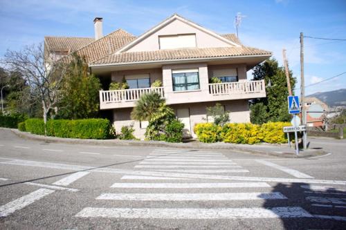 a crosswalk in front of a house on a street at Pensión Mosende in Porriño