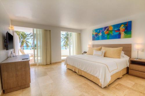 a bedroom with a large bed and a television at Hotel Casablanca in San Andrés