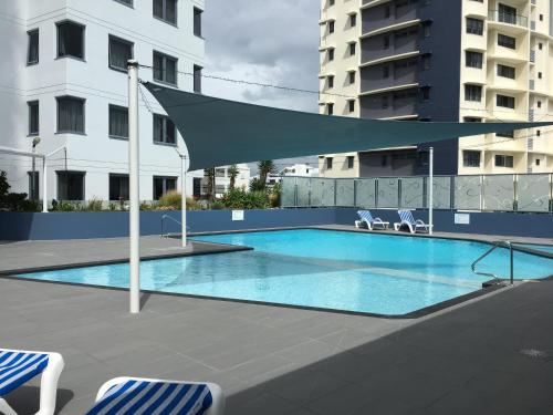 a large swimming pool with a canopy over it at Centrepoint Apartments Caloundra in Caloundra