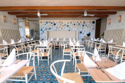 a dining room with white tables and chairs at Hotel Casablanca in San Andrés