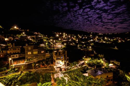 a view of a city at night with lights at Lungta BnB in Jiufen