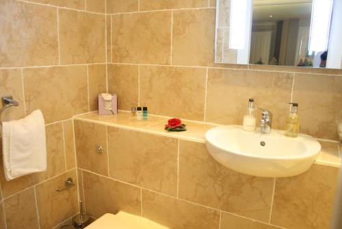a bathroom with a sink and a toilet and a mirror at Ayrs and Graces - Luxury Bed and Breakfast in Ayr