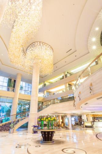 a large lobby with a large chandelier in a building at Wyndham Surabaya in Surabaya