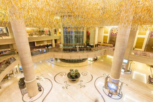 an overhead view of a lobby with a large ceiling at Wyndham Surabaya in Surabaya