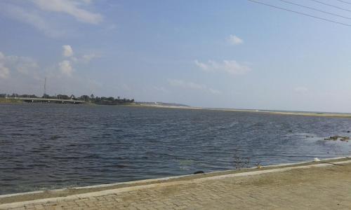 a large body of water with a beach in the background at Star Rest Beach Hotel in Arugam Bay