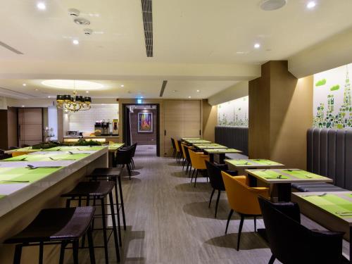 a dining room with long tables and chairs at Stay Hotel - Taichung Zhongqing in Taichung
