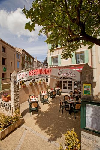 a restaurant with tables and chairs in front of a building at Le Signoret in Sault-de-Vaucluse