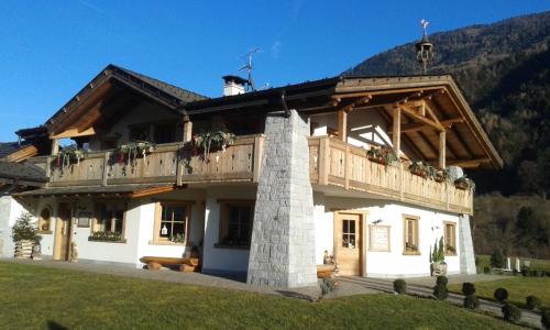 a large building with a balcony on top of it at Agriturismo Maso Grisun in Borzago