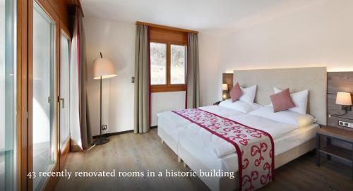 Ein Bett oder Betten in einem Zimmer der Unterkunft Hôtel des Vignes