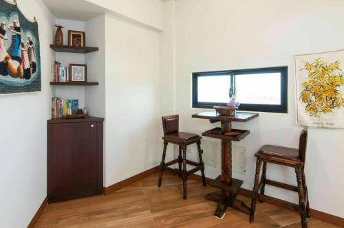 a room with two chairs and a table and a window at Longman Villa in Huxi