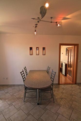 a dining room with a table and chairs in a room at Guest House Maxim in Liptovský Mikuláš