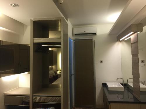 a small bathroom with a sink and a mirror at Grandboutique-Inn in Jakarta