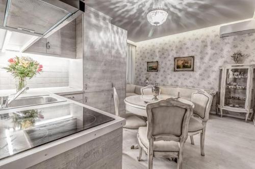 a kitchen with a sink and a table and chairs at Bebeto Suite in Corfu