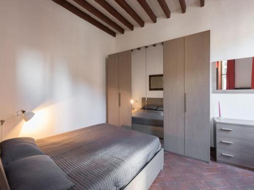 a bedroom with a bed and a dresser in it at Il Quartierino d'Oltrarno in Florence