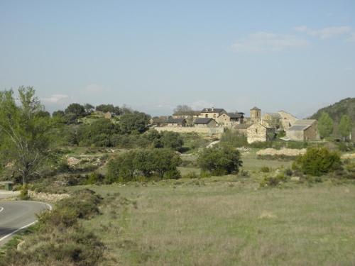 a house on a hill next to a road at Casa Rural Urbe in Campodarbe