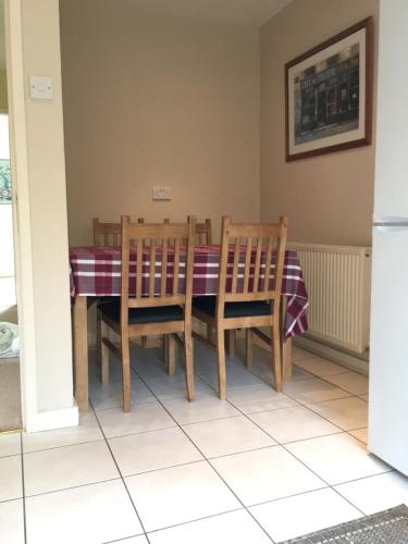 a dining room with a table and chairs at Fir Tree Cottage in Chester