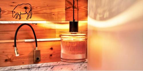 a glass jar of tea hanging from a wooden wall at Hotel Restaurant Au Boeuf Couronné in Paris