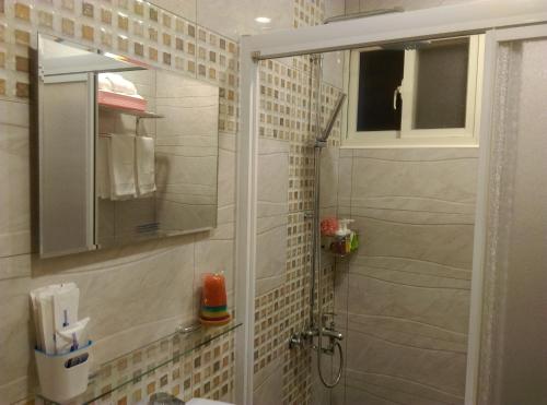 a bathroom with a shower with a glass door at Shuiquan 19N in Hengchun South Gate