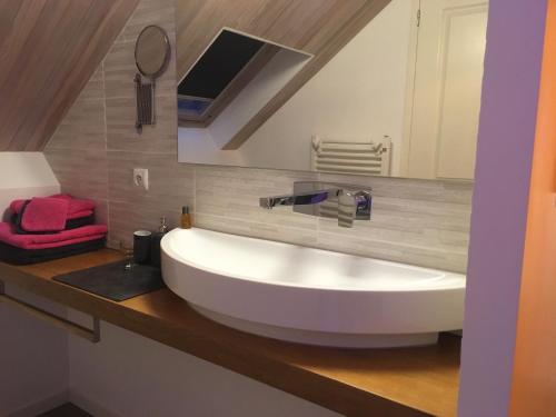 a bathroom with a large white sink on a counter at Moulin de la Fayolle in Blot-lʼÉglise