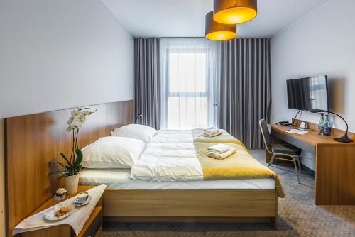 Säng eller sängar i ett rum på Hotel Garden