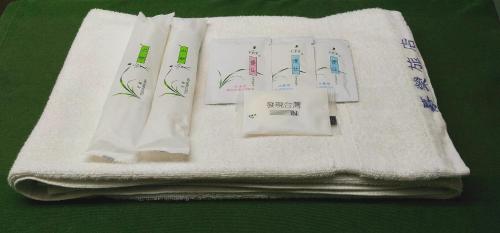 a group of white towels with writing on them at Chia Rong Hostel in Taipei