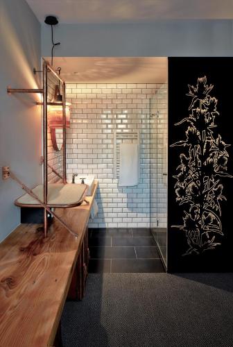 a bathroom with a sink and a mirror at Hotel Restaurant Au Boeuf Couronné in Paris