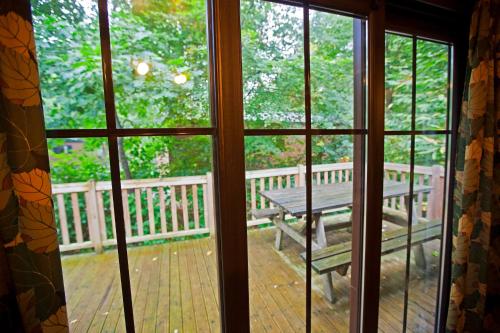 a view from a window of a porch with a picnic table at Disney Davy Crockett Ranch in Villeneuve-le-Comte
