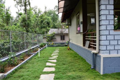 a garden on the side of a house at Srinikethana Home Stay with Swimming Pool in Madikeri