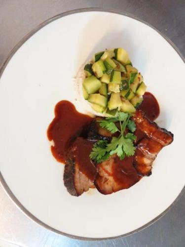 a plate of food with meat with apples and sauce at Hotel mon Soleil in La Gaude
