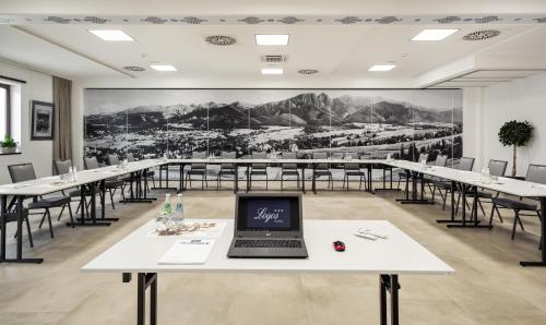 a conference room with tables and a laptop on a table at Hotel Logos in Zakopane