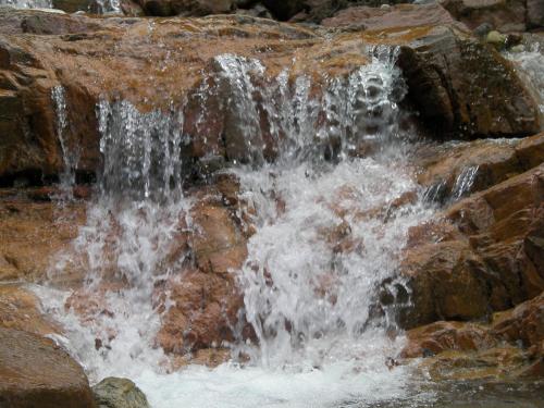 a stream of water flowing down a rocky waterfall at Haus Stablerkrämer in Maria Alm am Steinernen Meer