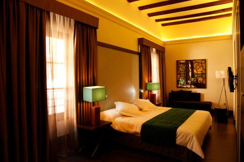 a hotel room with a bed and a window at Hotel Spa Martín el Humano in Segorbe