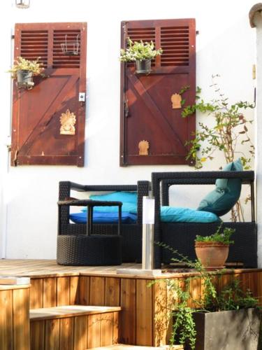 a porch with two chairs and two doors at Hotel mon Soleil in La Gaude