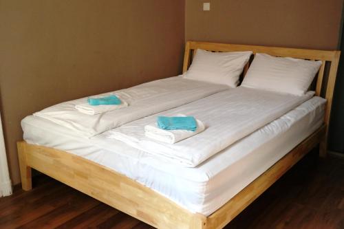 a bed with two towels on top of it at Market Square Apartment in Budapest