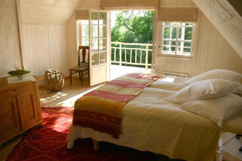 a bedroom with a large bed and a balcony at Pädaste Manor in Pädaste