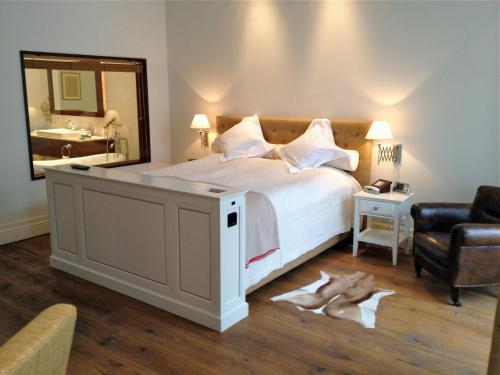 a bedroom with a large bed and a mirror at Pädaste Manor in Pädaste