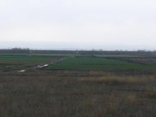 a field of grass with a road in the distance at Hotel Alfinden in Puebla de Alfindén