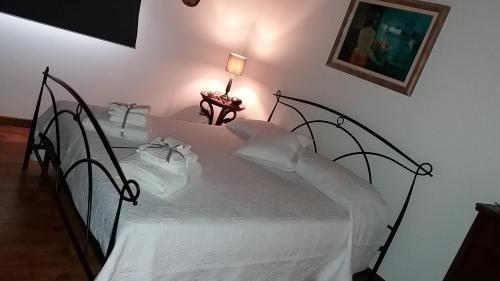 a bedroom with a bed with white sheets at Villa Posta Vecchia in Loreo