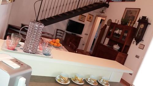 a kitchen with a counter with glasses and oranges on it at Villa Posta Vecchia in Loreo