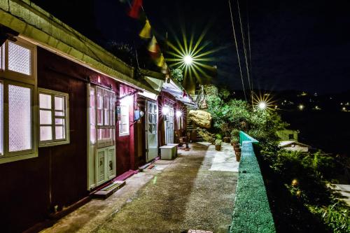 a walkway next to a building at night at Lungta BnB in Jiufen
