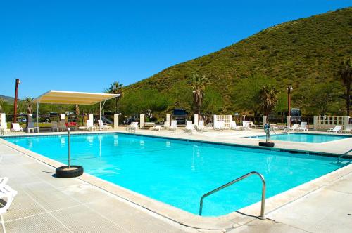 a large swimming pool with a mountain in the background at Pio Pico Camping Resort Studio Cabin 7 in Jamul