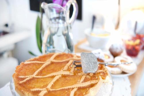 a cake sitting on top of a table with a spatula at A due Passi in Forte dei Marmi
