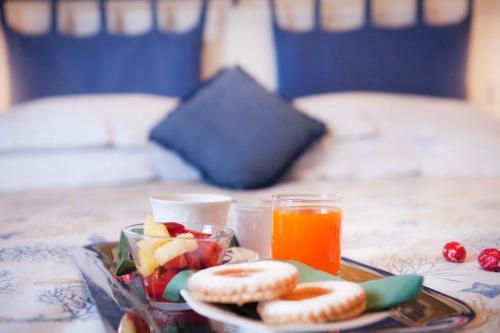 a plate of food with fruit and a drink on a table at A due Passi in Forte dei Marmi