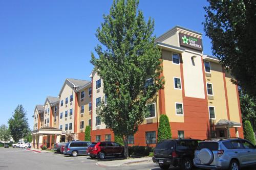 a building with cars parked in a parking lot at Extended Stay America Suites - Seattle - Kent in Kent