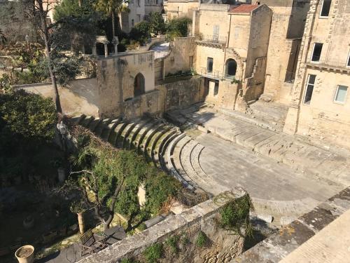 an old amphitheater in a city with buildings at Suite del Teatro Romano in Lecce