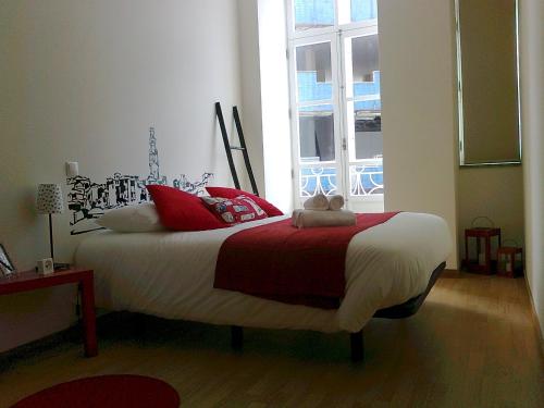 a bed room with a white bedspread and a large window at Formosa Oporto Apartments Group in Porto