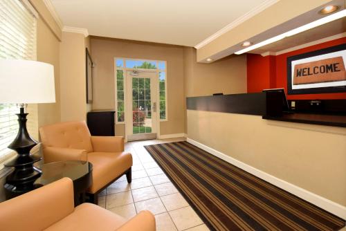 a lobby with a waiting room with a television at Extended Stay America Select Suites - Denver - Aurora South in Aurora